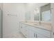 Bathroom featuring a double sink vanity with white cabinets and quartz countertop next to a large glass shower at 404 Famagusta Dr, Davenport, FL 33896