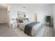 Comfortable bedroom with neutral color scheme and accent art creates a modern, serene space with a large bed at 404 Famagusta Dr, Davenport, FL 33896