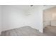 Bedroom with wood-look floors, closet, white walls, and open doorway creates an airy and minimalist retreat at 404 Famagusta Dr, Davenport, FL 33896