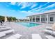 Community pool featuring lounge chairs, umbrellas, and modern architectural building at 404 Famagusta Dr, Davenport, FL 33896