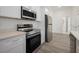 A well-equipped kitchen featuring stainless steel appliances and light quartz countertops at 404 Famagusta Dr, Davenport, FL 33896