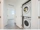 Convenient laundry room with stacked washer and dryer, providing space-saving functionality and ease of use at 404 Famagusta Dr, Davenport, FL 33896