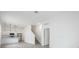 Open-concept living area with access to a modern kitchen and staircase leading to upper level at 404 Famagusta Dr, Davenport, FL 33896