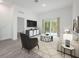 An airy living room with white accents, decorative furniture, and sliding glass doors to the backyard at 404 Famagusta Dr, Davenport, FL 33896