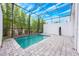 Screened-in pool featuring brick patio, mature bamboo, and plenty of sunshine at 404 Famagusta Dr, Davenport, FL 33896