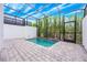 Screened-in pool featuring brick patio, mature bamboo, and plenty of sunshine at 404 Famagusta Dr, Davenport, FL 33896
