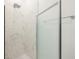 Bright shower room with marble walls, glass door, and modern fixture create a luxurious bathing experience at 404 Famagusta Dr, Davenport, FL 33896