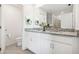 Bright bathroom with double sink vanity, granite countertop, and shower with glass door at 4129 Lavender Ct, Lake Hamilton, FL 33851