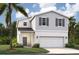 Charming two-story home features a classic design with a 2-car garage and well-manicured lawn at 4129 Lavender Ct, Lake Hamilton, FL 33851