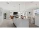 Open-concept kitchen, dining, and living areas with pendant lighting and modern fixtures at 4129 Lavender Ct, Lake Hamilton, FL 33851