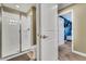 Modern bathroom showcasing a glass-enclosed shower, toilet, and doorway leading to bedroom at 424 Ocean Course Ave, Davenport, FL 33896