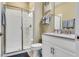 Well-maintained bathroom features a glass shower, a neutral color palette, and ample lighting at 424 Ocean Course Ave, Davenport, FL 33896