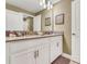 Well-lit bathroom featuring a double vanity with white cabinetry and neutral wall color at 424 Ocean Course Ave, Davenport, FL 33896