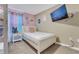 Comfortable bedroom with a twin bed, mounted TV, and ample natural light at 424 Ocean Course Ave, Davenport, FL 33896