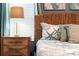 A bedroom with wicker headboard and side table with lamp at 424 Ocean Course Ave, Davenport, FL 33896
