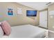 Comfortable bedroom with a twin bed, wall decor, and ample natural light at 424 Ocean Course Ave, Davenport, FL 33896