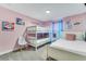 Inviting bedroom featuring a bunk bed, twin bed, pink walls, and decor at 424 Ocean Course Ave, Davenport, FL 33896