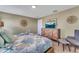 Comfortable bedroom features a bed with starfish theme and warm tones, with a wall-mounted tv at 424 Ocean Course Ave, Davenport, FL 33896