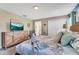Comfortable bedroom features a bed with starfish theme and warm tones, with a wall-mounted tv at 424 Ocean Course Ave, Davenport, FL 33896