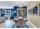 Elegant dining area open to living room with modern chandelier and backyard views at 424 Ocean Course Ave, Davenport, FL 33896