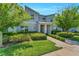 Attractive gray townhouse with landscaped yard, creating a welcoming curb appeal at 424 Ocean Course Ave, Davenport, FL 33896