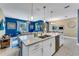 Open-concept kitchen featuring an island with stainless steel appliances adjacent to a living area at 424 Ocean Course Ave, Davenport, FL 33896