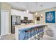 Modern kitchen with a large island, stainless steel appliances, and ample counter space at 424 Ocean Course Ave, Davenport, FL 33896