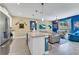 Well-lit kitchen featuring a spacious island with bar seating, adjacent to a comfortable living area at 424 Ocean Course Ave, Davenport, FL 33896
