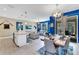 Open-concept living space with kitchen island, dining area, and comfortable seating at 424 Ocean Course Ave, Davenport, FL 33896