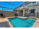 A beautiful screened-in swimming pool and patio area features a safety fence at 424 Ocean Course Ave, Davenport, FL 33896