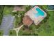 Aerial view of a community pool and recreation center with ample parking and a nearby playground at 4265 Foxhound Dr, Clermont, FL 34711