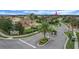 Scenic view of the Hunters Run community with lush landscaping, palm trees, and well-maintained streets at 4265 Foxhound Dr, Clermont, FL 34711