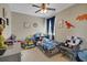 bedroom featuring ceiling fan, picture window and bed with colorful blanket and pillows at 4265 Foxhound Dr, Clermont, FL 34711