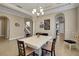 Bright dining room with tile flooring, tray ceiling, decorative chandelier, and views of staircase at 4265 Foxhound Dr, Clermont, FL 34711