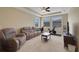 Inviting living room with plush couches, a tray ceiling, and an exercise bike at 4265 Foxhound Dr, Clermont, FL 34711