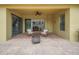 Covered patio with brick floors, comfortable wicker furniture, and a fan overhead at 4265 Foxhound Dr, Clermont, FL 34711