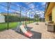 Screened in patio with brick floors, play set and a stainless steel grill at 4265 Foxhound Dr, Clermont, FL 34711