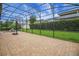 Screened in patio with brick floors, a basketball hoop and lush green grass in the background at 4265 Foxhound Dr, Clermont, FL 34711