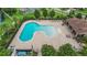 Aerial view of a community pool with surrounding lounge chairs and a covered seating area at 4265 Foxhound Dr, Clermont, FL 34711