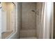 Updated walk-in shower with tiled walls, a built-in bench, and glass door at 4265 Foxhound Dr, Clermont, FL 34711