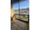 Balcony with screened enclosure overlooking parking area and manicured lawn, with green space at 445 Fountainhead Cir # 262, Kissimmee, FL 34741