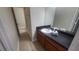 Bathroom featuring a vanity with granite countertop and ceramic tile flooring at 445 Fountainhead Cir # 262, Kissimmee, FL 34741
