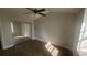 A bedroom with a ceiling fan, wood floors, and a mirrored closet at 445 Fountainhead Cir # 262, Kissimmee, FL 34741