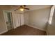 Bedroom featuring modern flooring, neutral paint, a ceiling fan and closet space at 445 Fountainhead Cir # 262, Kissimmee, FL 34741