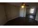 Bedroom featuring dark wood floors, ceiling fan, and mirrored closet doors at 445 Fountainhead Cir # 262, Kissimmee, FL 34741