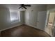 A bedroom with a ceiling fan, wood floors, and a window nook with a cushioned seat at 445 Fountainhead Cir # 262, Kissimmee, FL 34741