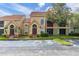 Charming two-story condo featuring tile roofing and lush landscaping at 445 Fountainhead Cir # 262, Kissimmee, FL 34741