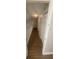 An upstairs hallway with wood flooring and a white railing at 445 Fountainhead Cir # 262, Kissimmee, FL 34741