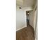 Hallway with wood floors leading to a bedroom with a ceiling fan and neutral walls at 445 Fountainhead Cir # 262, Kissimmee, FL 34741
