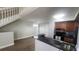 Open-concept kitchen with black countertops, wooden cabinets, and a cozy breakfast bar at 445 Fountainhead Cir # 262, Kissimmee, FL 34741